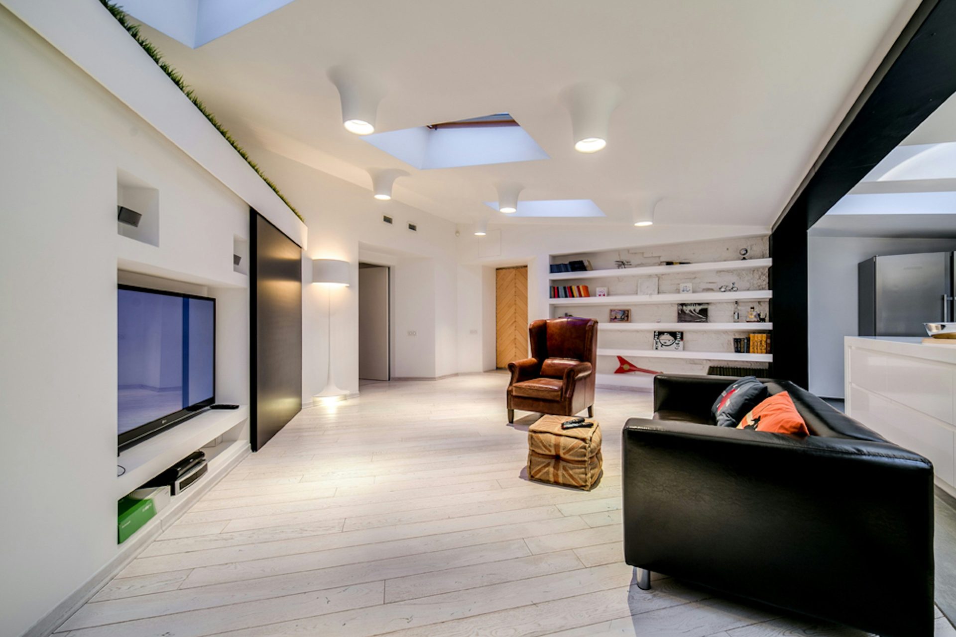 a living room filled with furniture and a flat screen tv